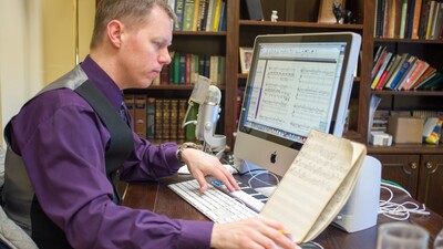 PCG music director Ryan Malone notates "Spread It Before the Lord" from The Book of Isaiah. (Photo: Matthew Friesen)