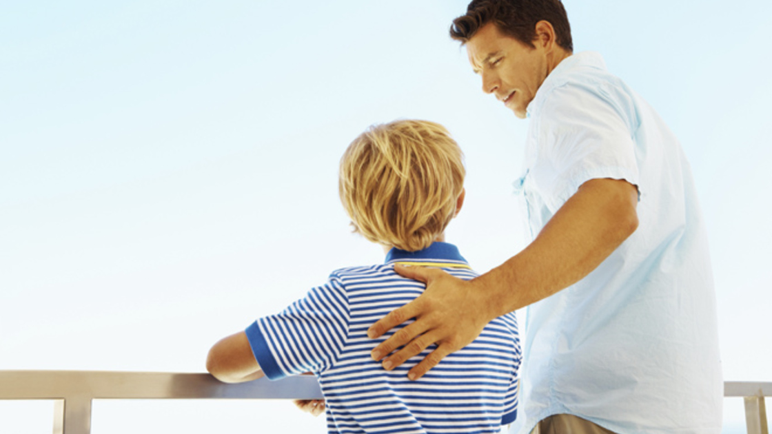 Photo of a father teaching self control to a son, as Christian family should.