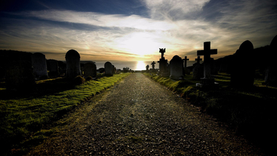 Photo of road going through cemetry, where people lie buried that will be resurrected in one of three resurrections found in the Bible.