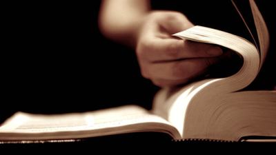 A photo of a man studying the Bible about the power of words.