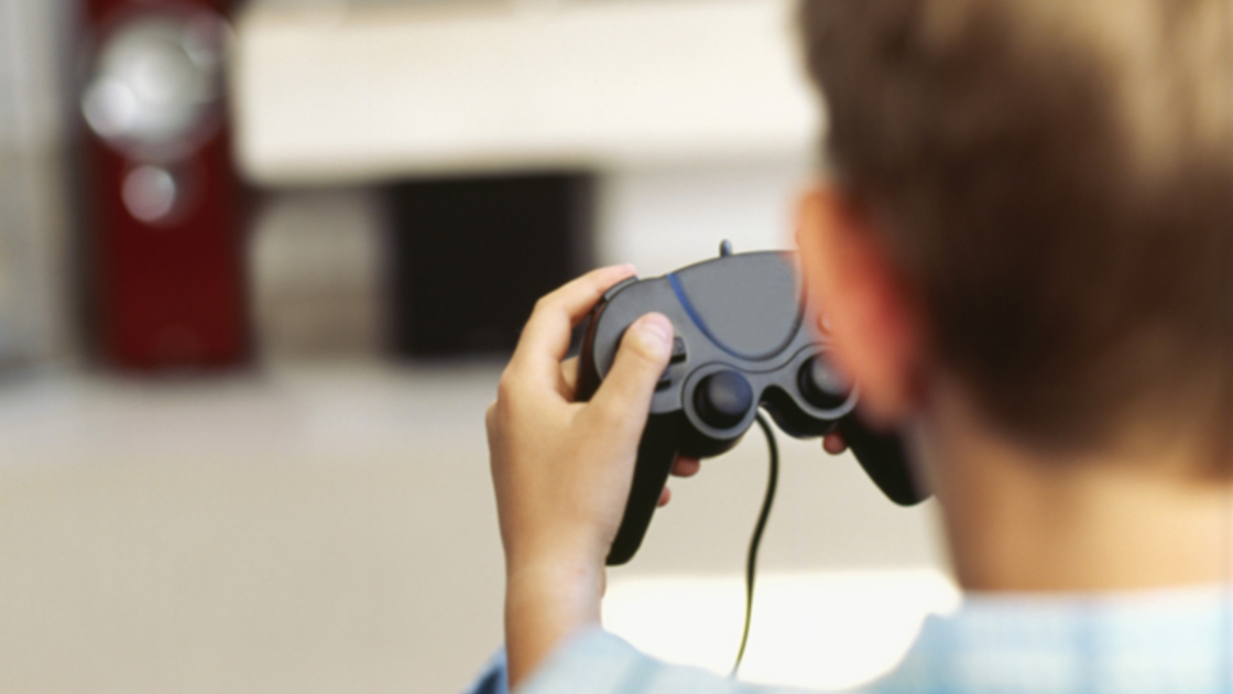 rear view of a boy playing a video game