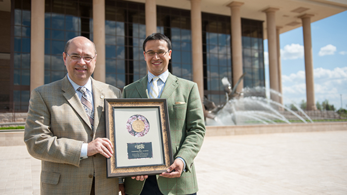 Armstrong Auditorium representatives Shane Granger and Edwin Trebels hold the auditorium's award on the grand mall. (Photo: Matthew Friesen) 