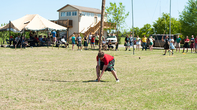 Brandon Nice lifts a caber while Daniel Westerbaan tosses a sheaf at the Gary Rethford Highland Games held on the campus of Herbert W. Armstrong College (Photo: Matt Friesen). 