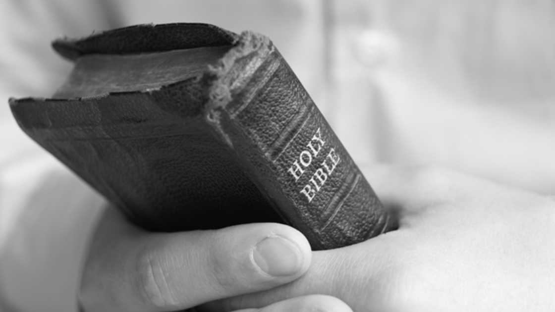 Young man holding bible