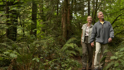 USA, Washington, mature man and woman walking on footpath