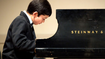 Young boy playing piano