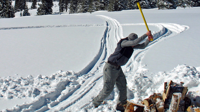 Man chopping wood in the snow