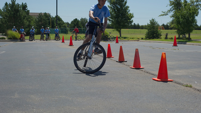 A camper from 2B rides through the obstacle course. 