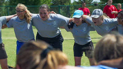 Girls from 5G circle up and cheer as the softball staff decide who to award a ticket. 