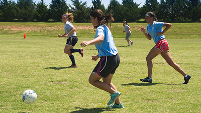 Ariana (2G) runs with the ball while her dorm mate Callie runs along side for support. 