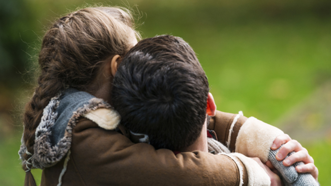 Father and Daughter hugging from the back.