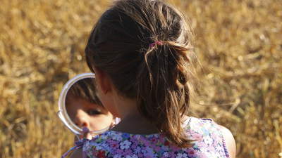 Little girl looking in the mirror