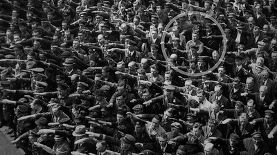 Only man not saluting Hitler
