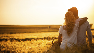 Loving couple in wheat field.