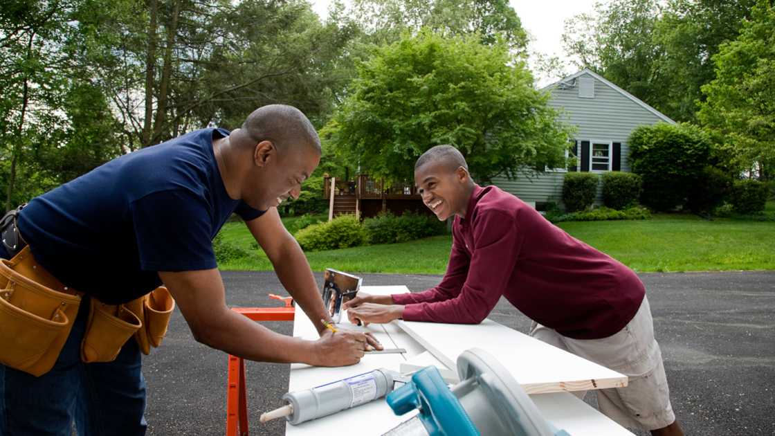 Father and son working on house