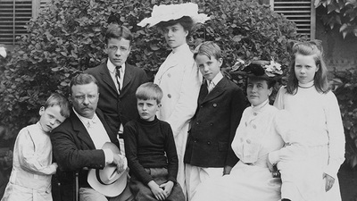 President and Mrs. Theodore Roosevelt seated on lawn, surrounded by their family; 1903.