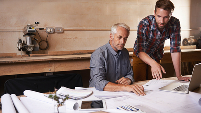 Cropped shot of a father and son working together in their workshop