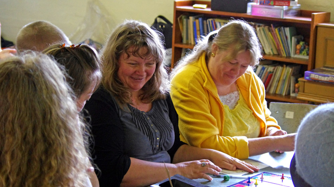 Joh Smith and Linda Hoeksma play board games.