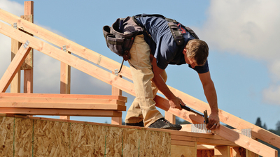 Layout and installation of roof rafters on a new commercial residential construciton project by framing contactors