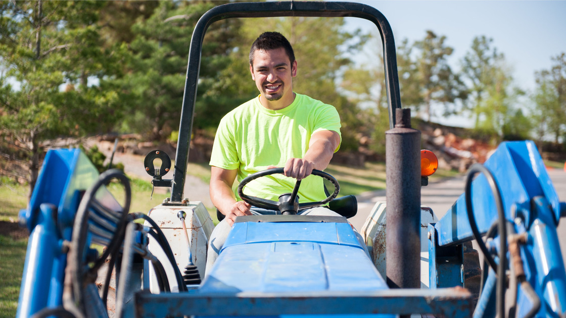 AC sophomore James Lowry drives a tractor for the landscaping department. 