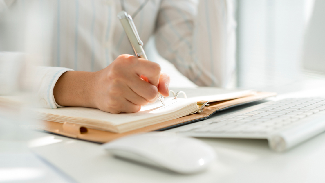 Hand of business manager making notes, selective focus