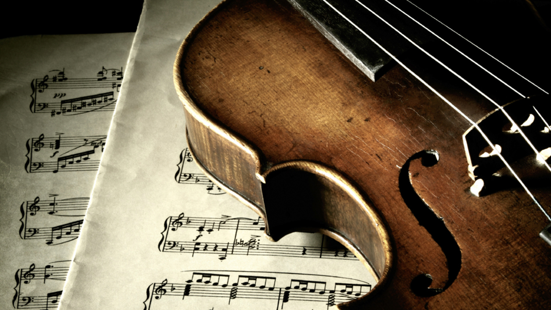 16x9(Face the Music)
Music collection: Old scratched violin on music sheet in shadow. Vintage style.