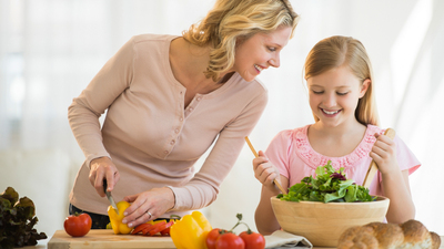 16x9(What you can do)
Happy little girl assisting mother in preparing food at kitchen counter