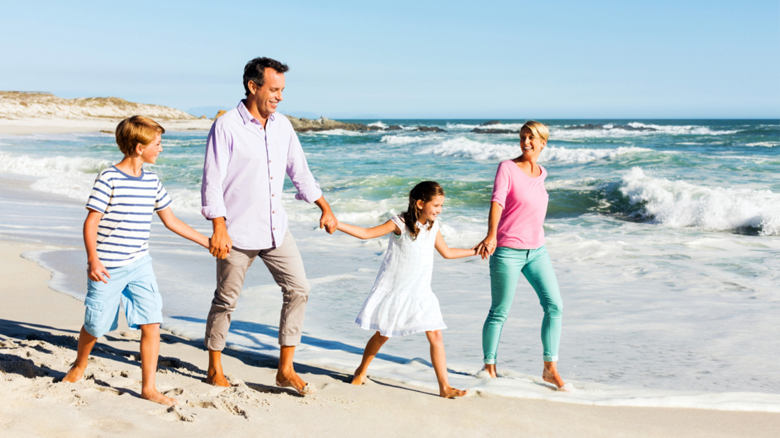 16x9(Pentecost and God family)
Full length of little children and parents holding hands while walking on beach with clear blue sky in background. Horizontal shot.