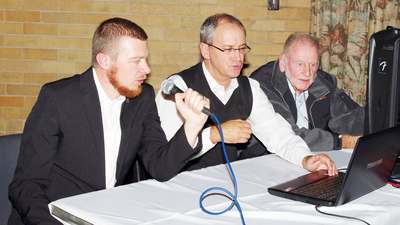 Race commentator Rohann Smith, scorekeeper Trevor Laubscher and sound crew member Ben Murphy carefully watch the race. 