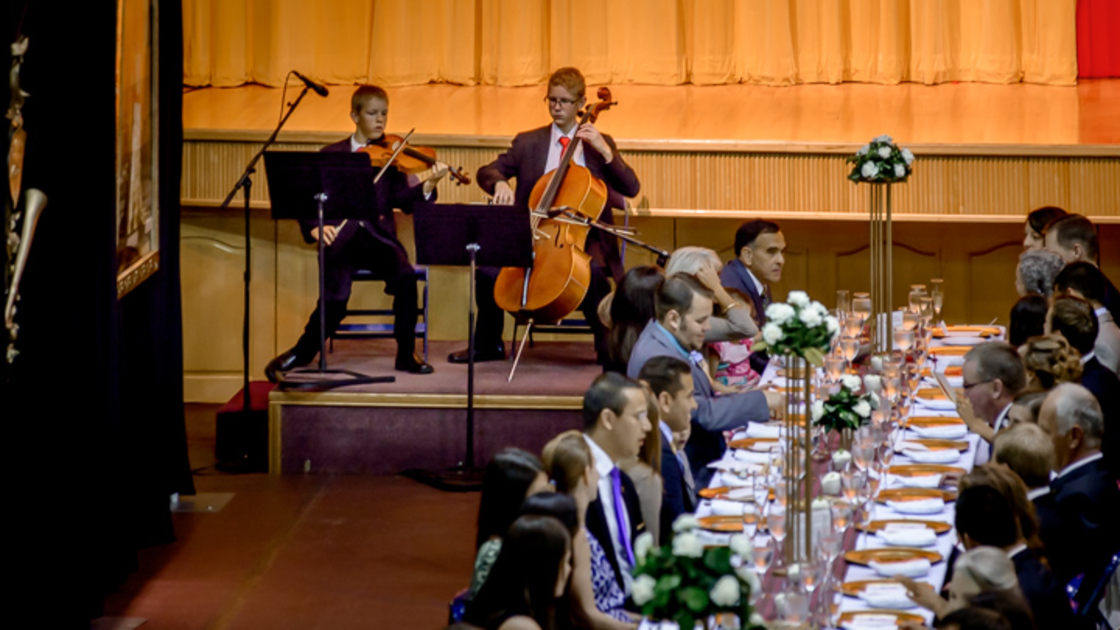 EZEKIEL AND SETH MALONE PLAY CLASSICAL MUSIC WHILE FACULTY, STUDENTS AND FAMILIES CONVERSE DURING GRADUATION BRUNCH