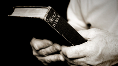 16x9(Man holding a Bible)