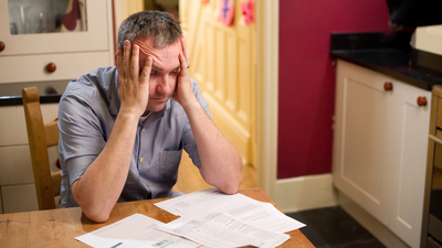 Exasperated man trying to pay bills