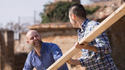 16x9(Live with energy)
Happy european workmen arranging building timber at farm