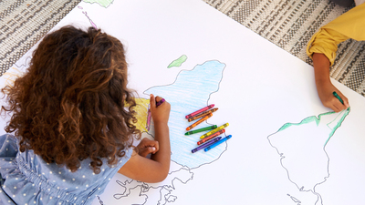 16x9(Stay in the lines)
High angle shot of two young children coloring in a map of the world