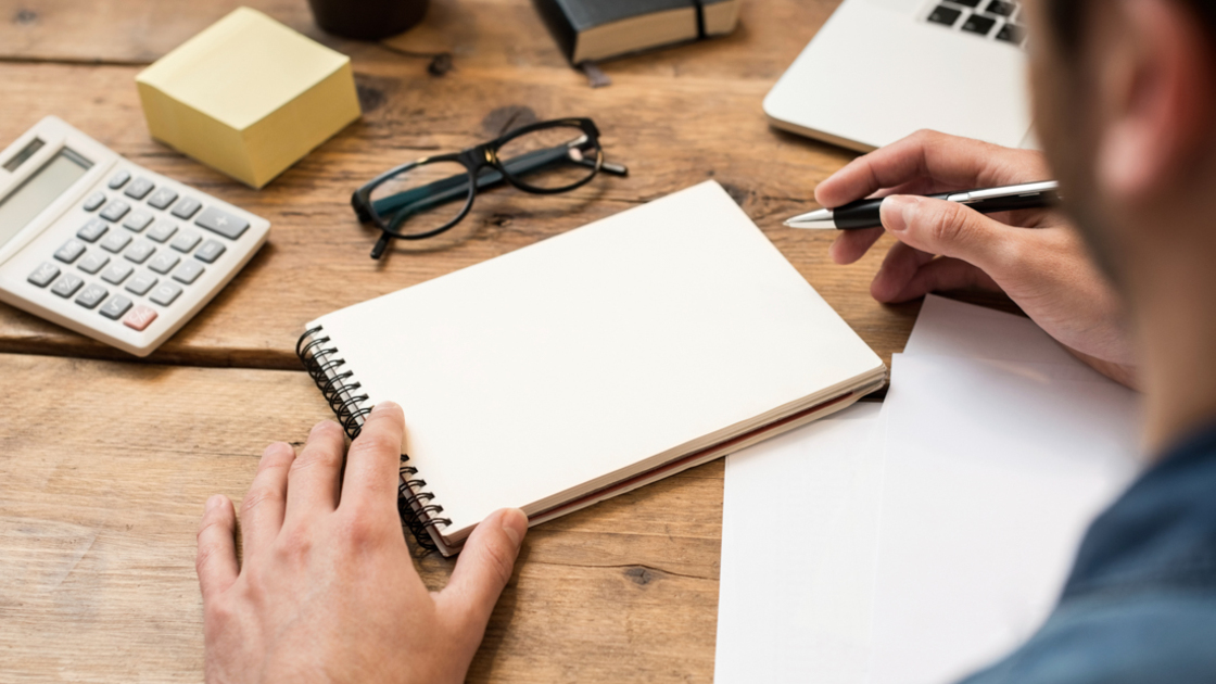 16x9(Eyes on the goal)
Businessman writing or drawing a note in a blank notebook