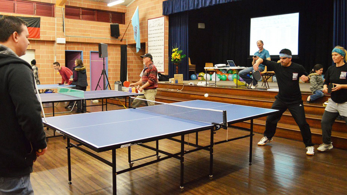 Philadelphia Church of God member Ray Simpson returns the serve from David Kulsenberg as Storm Simpson looks on. 