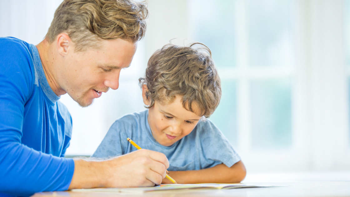 16x9(Men report for duty)
A father is sitting at a desk with his son - they are working on a homeschooling assingment together.