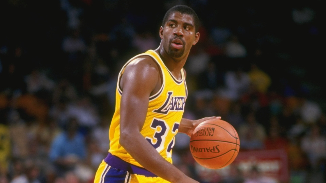 Earvin Magic Johnson of the Los Angeles Lakers passes the ball up