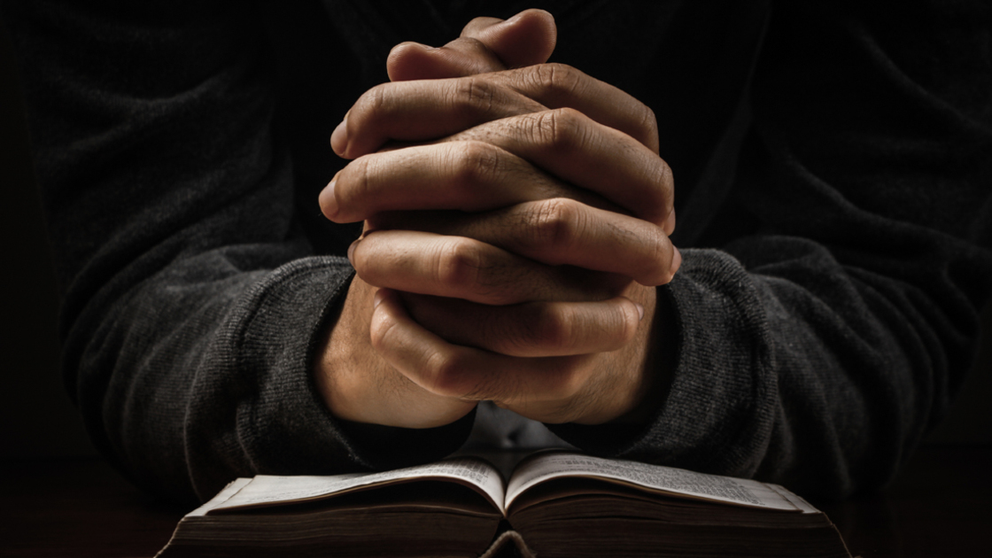 16x9(Prayers of a priest)
Praying man hand and bible on desk.