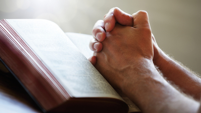 16x9(Conquer Spiritual Lethargy)
Hands folded in prayer on a Holy Bible in church concept for faith, spirtuality and religion