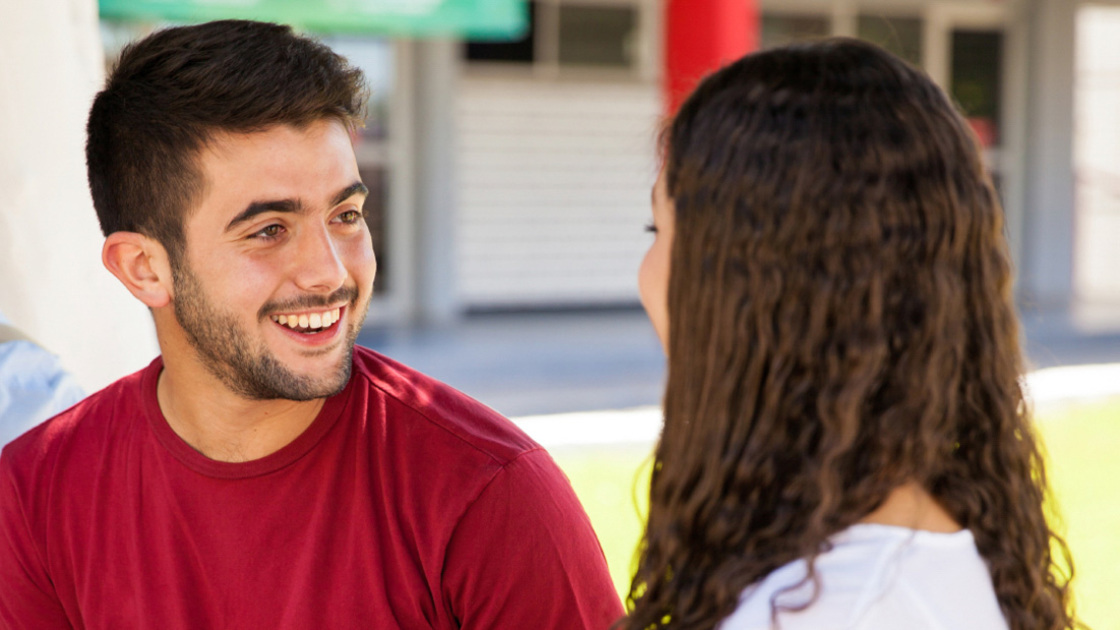 16x9(How does emotion affect your dating)
Handsome Hispanic guy talking with a cute curly brunette at school