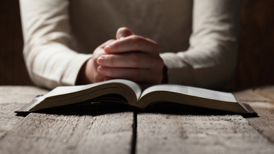 16x9(What is meditation?)
Woman hands praying with a bible in a dark over wooden table