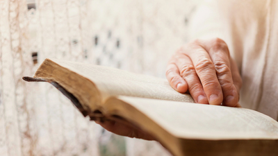 16x9(How not to be deceived)
Unrecognizable woman holding a bible in her hands