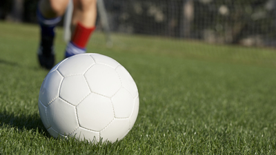 Soccer player about to kick a soccer ball.