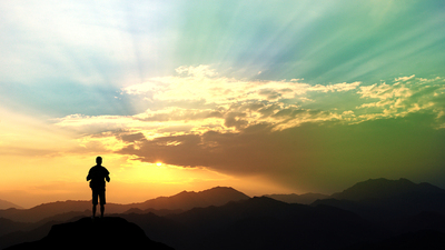 man climbing on mountain in the morning.