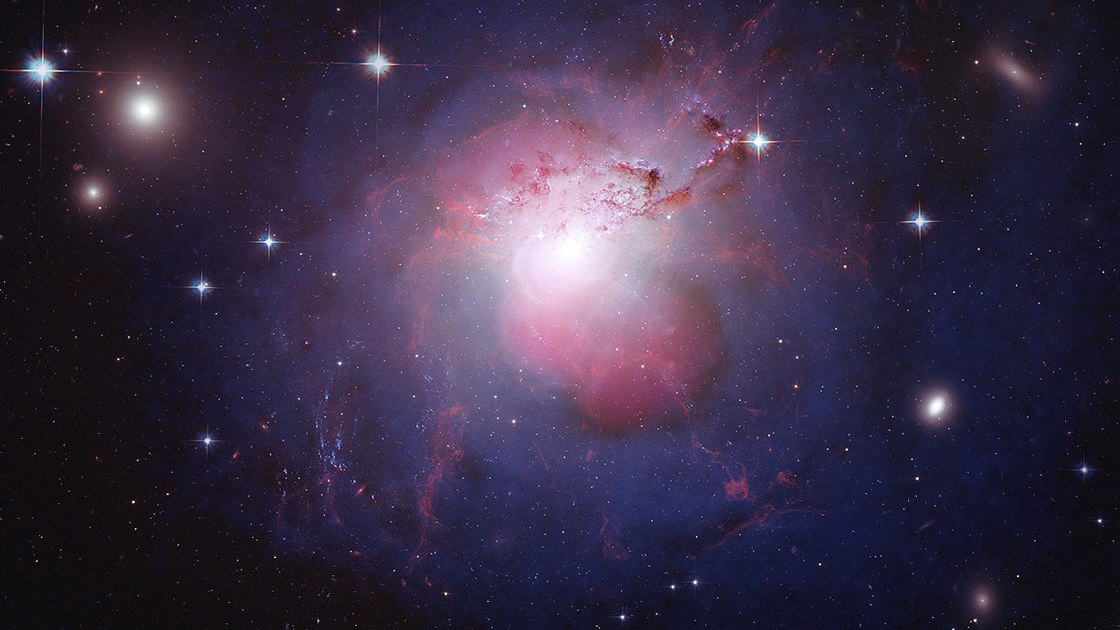 The active galaxy NGC 1275 lies at the center of the cluster of galaxies known as the Perseus Cluster. By combining multi-wavelength images into a single composite, the dynamics of the galaxy are more easily visible. In this composite image, X-rays from Chandra are shown in violet and reveal the presence of a black hole at the center of NGC 1275. Optical data from Hubble is depicted in red, green, and blue, and radio emission in pink traces the jets generated from the central black hole.