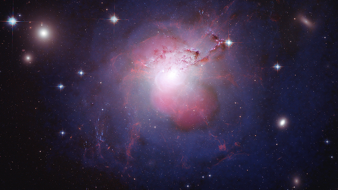 The active galaxy NGC 1275 lies at the center of the cluster of galaxies known as the Perseus Cluster. By combining multi-wavelength images into a single composite, the dynamics of the galaxy are more easily visible. In this composite image, X-rays from Chandra are shown in violet and reveal the presence of a black hole at the center of NGC 1275. Optical data from Hubble is depicted in red, green, and blue, and radio emission in pink traces the jets generated from the central black hole.