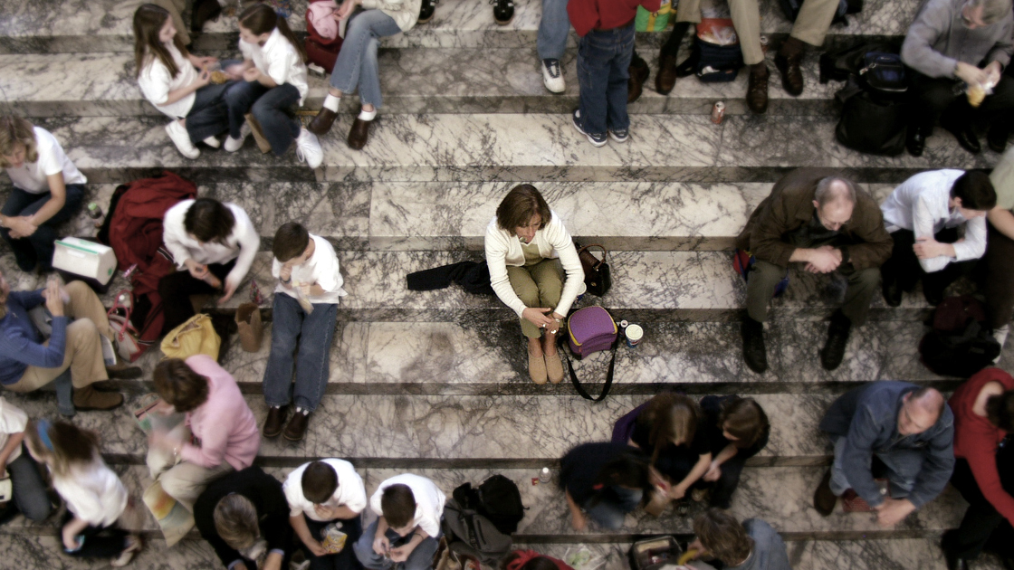 Alone in a crowd ... image was intentionally softened and colors muted to all but the alone person.     