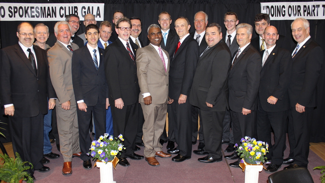 The men in the photo, from left to right, are as follows: Maurice Chevrier, Tony Chiasson, Rod Kelsey, Dan Gauvreau, Daniel Di Santo, Greg Bergsma, Bill Lawrence, Laskey Hart, Michael Lauzon, Mr. Fred Dattolo, Raj Ebenezer, Mr. David Weeks, David Robinson, Rein Westerbaan, Alex Lovell, Tyrel Schlote, Ron Hanson, John Jones, Steve Maydanski, and Robert Friesen.