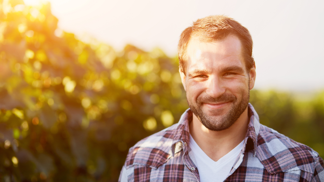 Portrait of a young winemaker in vineyard, toned.